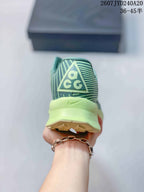 Rear view of the sneaker showing ACG heel branding, a pale lime heel section, and the outsole edge.