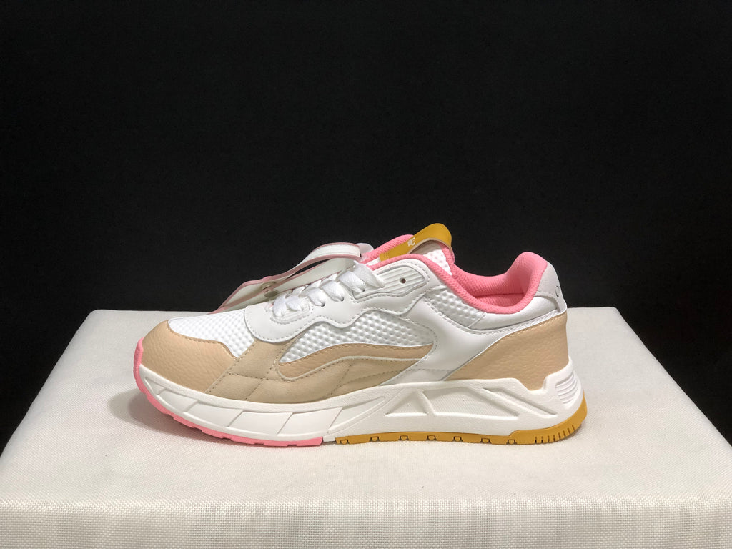 Lateral side view showing the beige overlays, textured white panels, pink collar and layered sole.