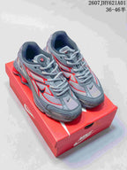 Pair of grey and red Nike Shox Ride 2 sneakers on a red shoe box