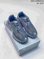 Pair of black New Balance 327 low-top sneakers displayed on a shoebox