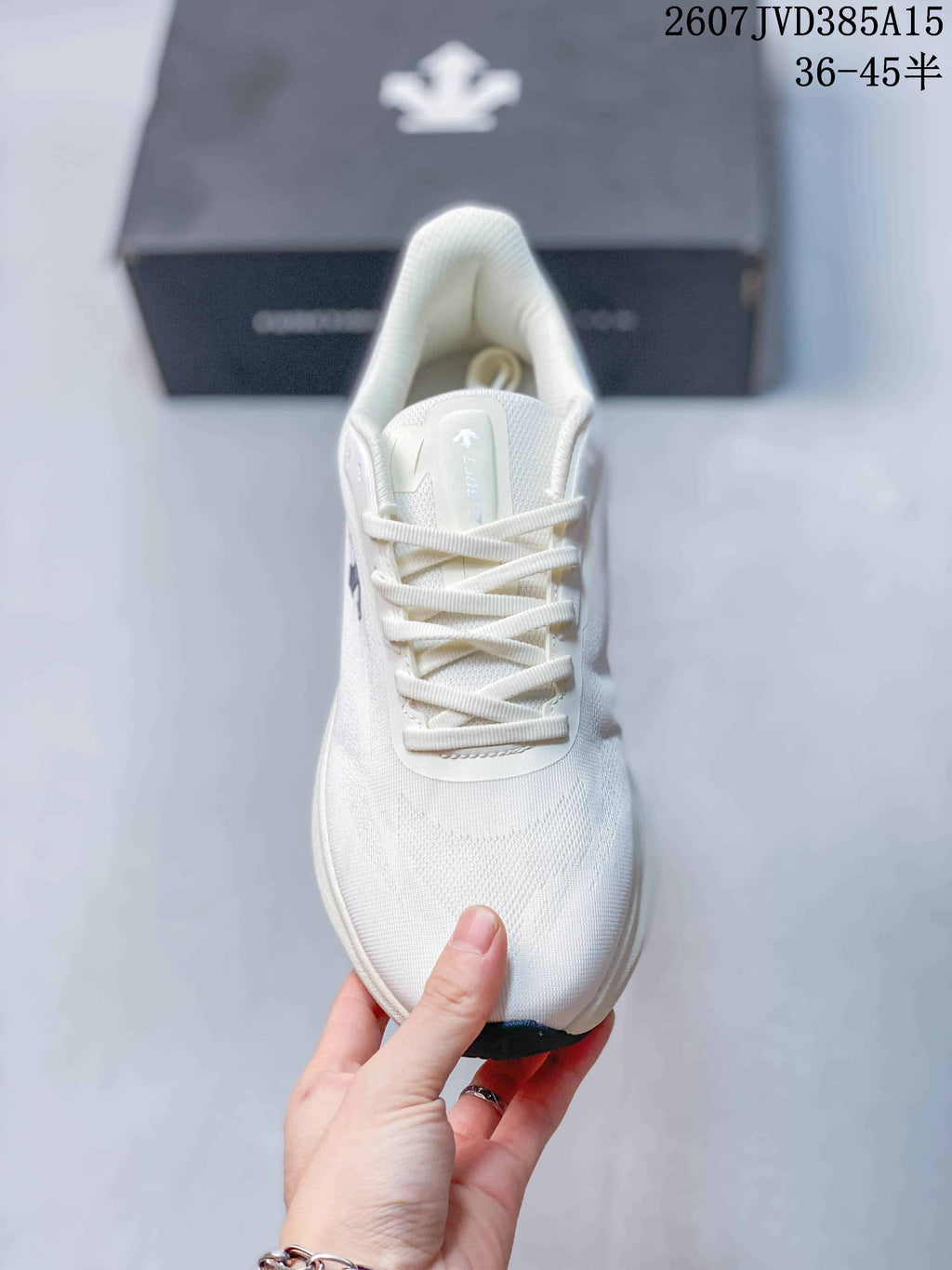 Top view of the white sneaker showing the rounded toe, laces, tongue and padded collar.