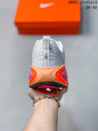 Rear view showing the padded heel, pull tab, and layered orange and pink midsole.