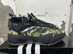 Side profile showing camouflage panels, three stripe details, and a dark sculpted sole.
