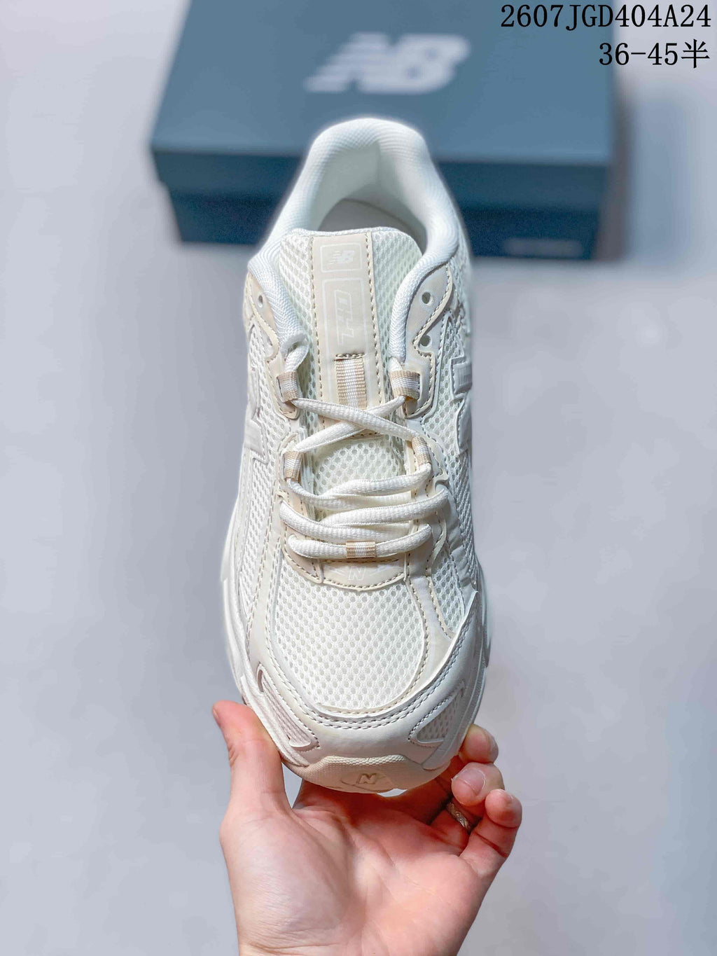 Top view of the beige sneaker showing the mesh toe box, tongue and lace system.
