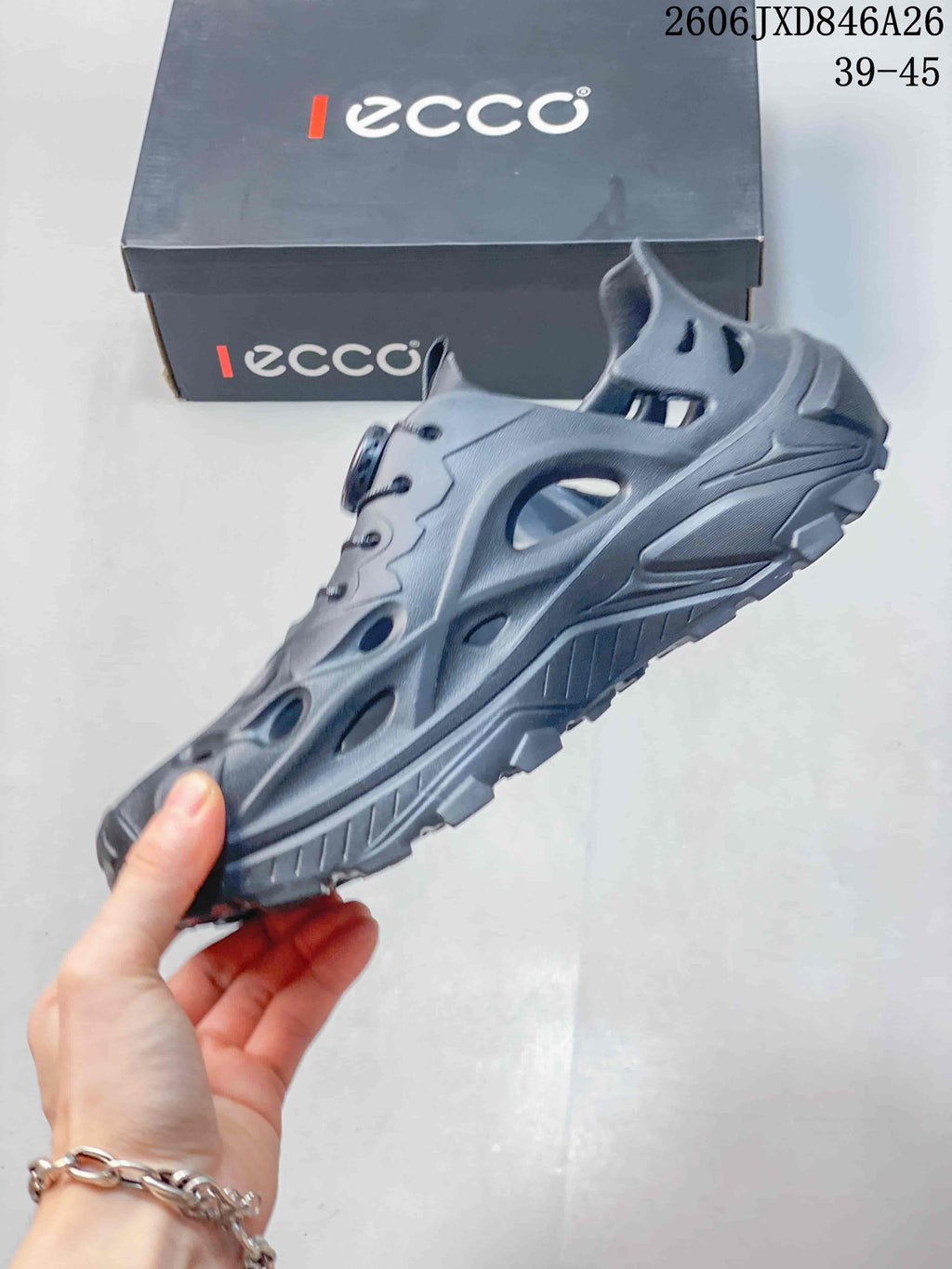 Side profile of a gray closed-toe clog with ventilation openings and a treaded sole.