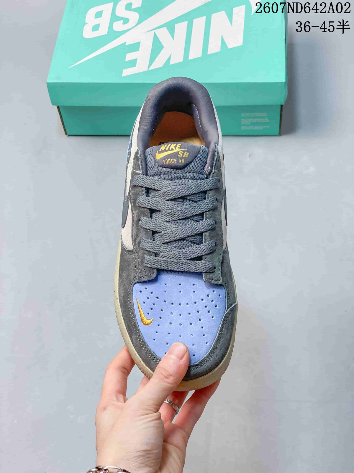 Top view of the lace-up shoe with a perforated light blue toe panel and yellow accent