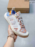 Side view of the shoe showing white panels and blue-and-orange patterned fabric
