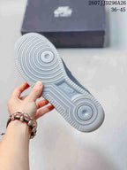 Underside view of a grey sneaker showing the circular rubber outsole pattern and central Nike detail; image text shows 2607JJD296A26 and 36–45.