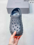 Top view of the black perforated clog with a closed toe and adjustable rear strap.