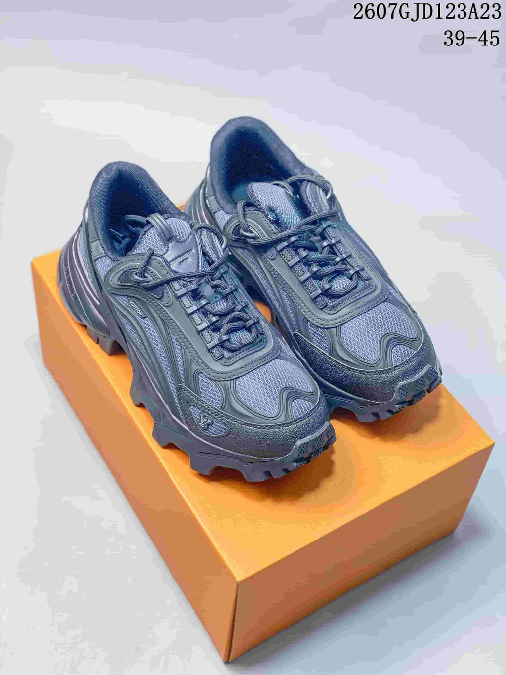 Pair of dark gray Louis Vuitton Summit chunky sneakers displayed on an orange shoe box; style code 2607GJD123A23 and size range 39-45 are visible at the top.