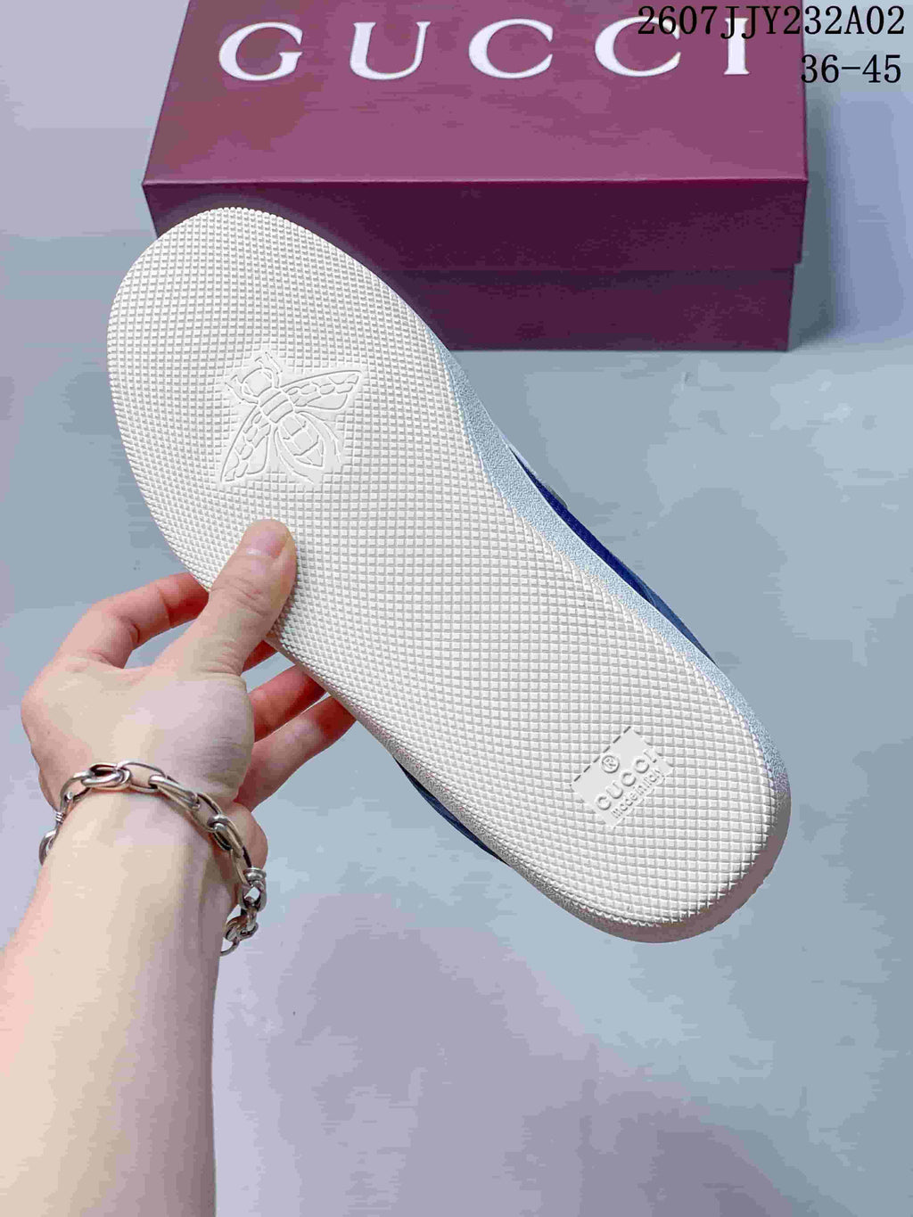 Close-up of the white textured outsole and embossed emblem