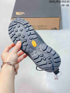 Close-up of the lugged shoe outsole with a Vibram mark.