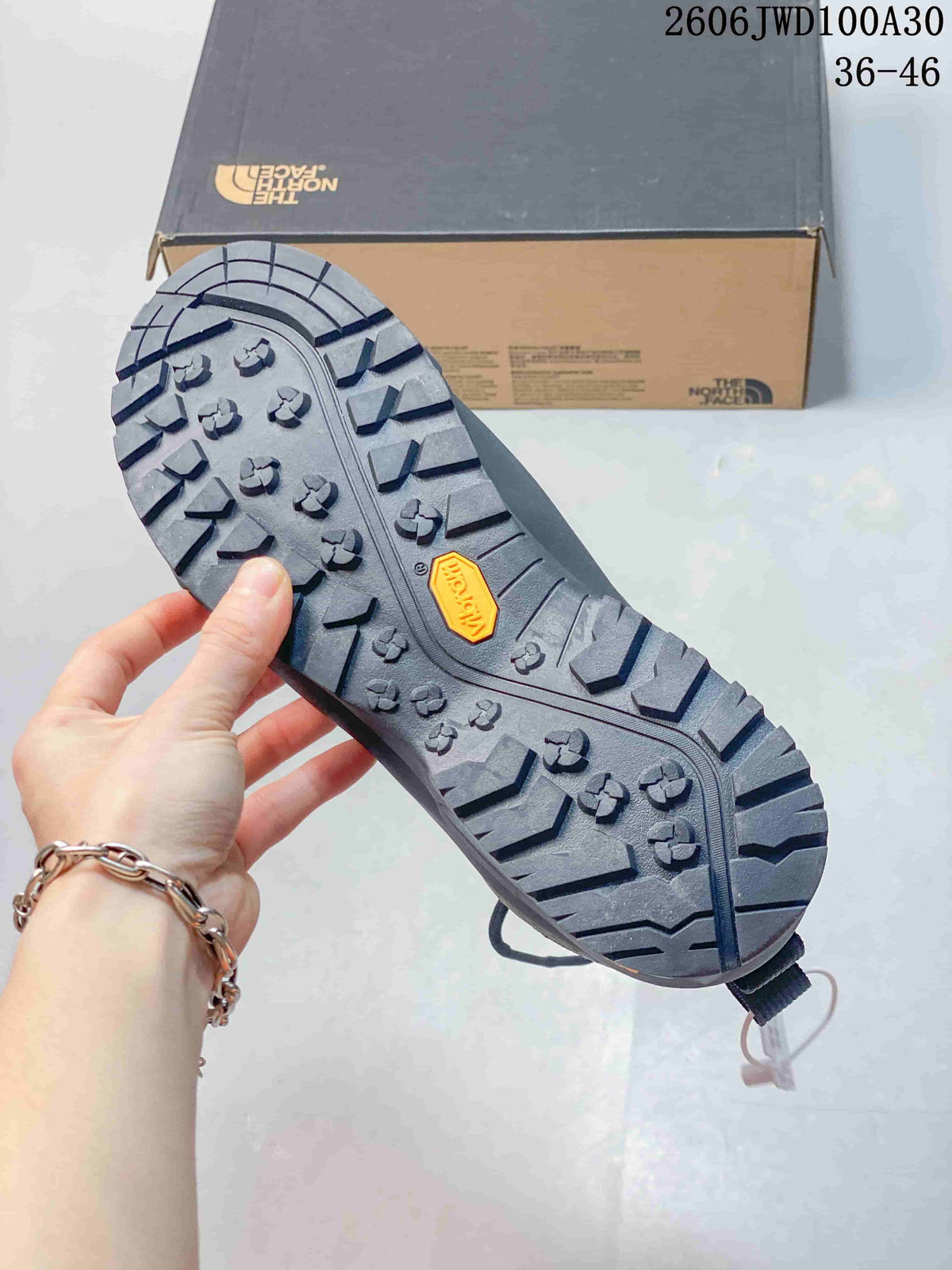 Close-up of the lugged shoe outsole with a Vibram mark.