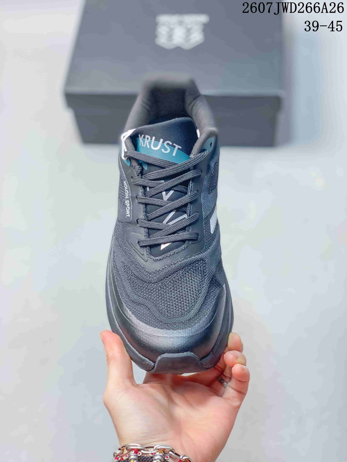 Front view of a dark KRUST trail running shoe showing the woven toe area, laces, padded collar, and KRUST tongue branding.