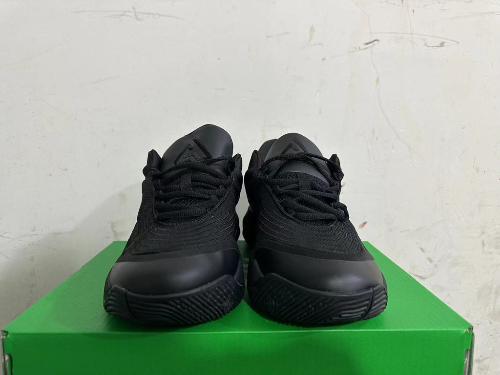 Front view of the all-black lace-up sneakers.
