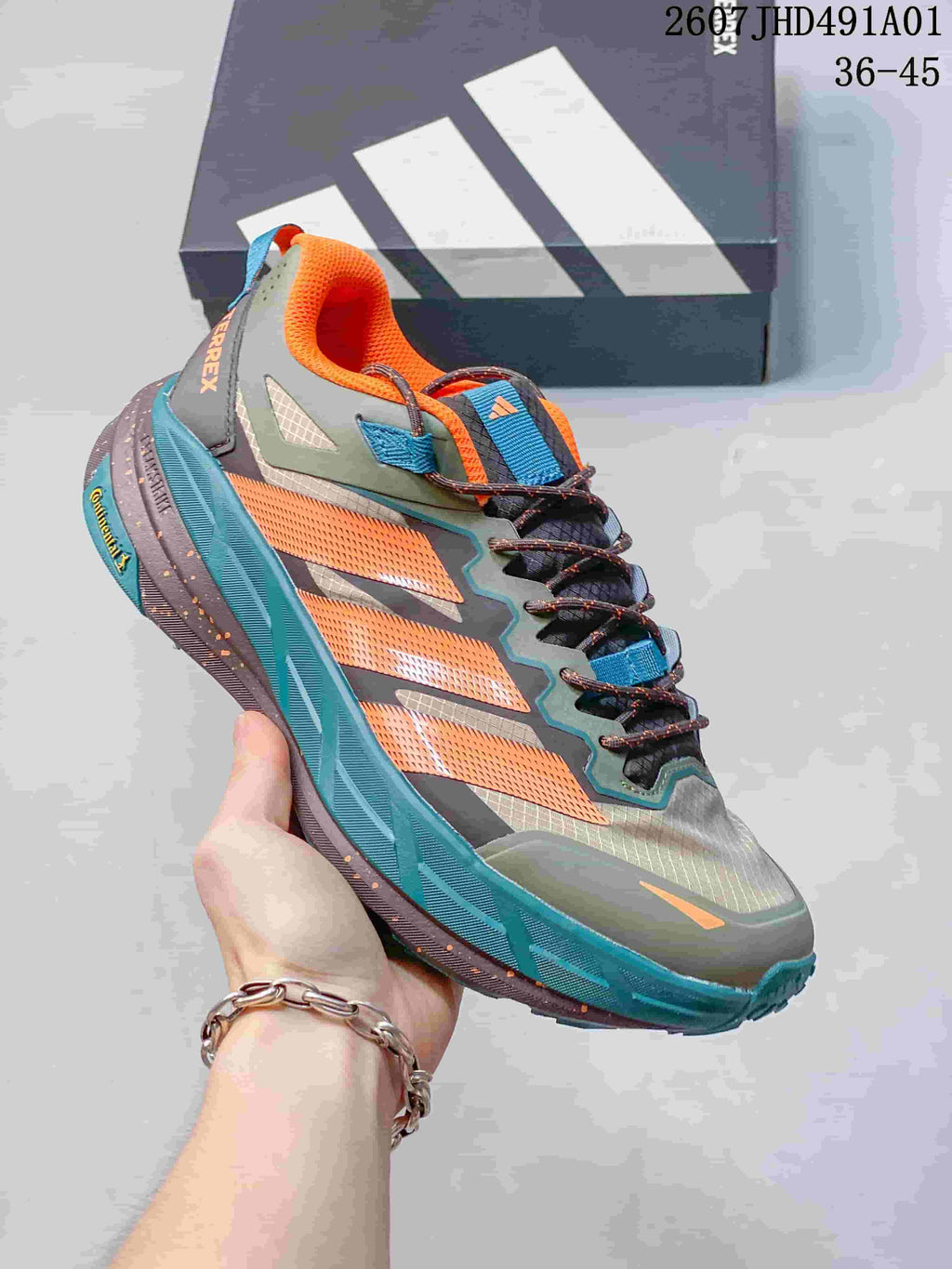 Gray Adidas Terrex low-top shoe with orange and teal accents; image displays the size range 36–45.