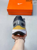 Rear view of the sneaker showing the padded heel, gold heel detail and layered white midsole.