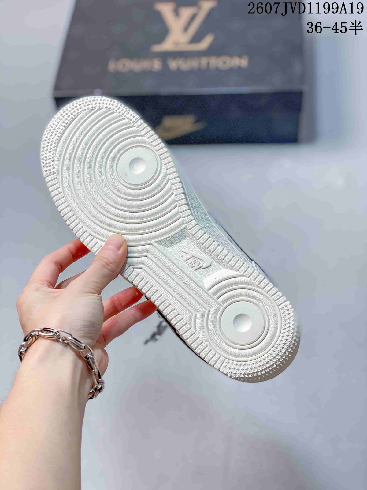 Close view of the white circular-patterned outsole on a sneaker.