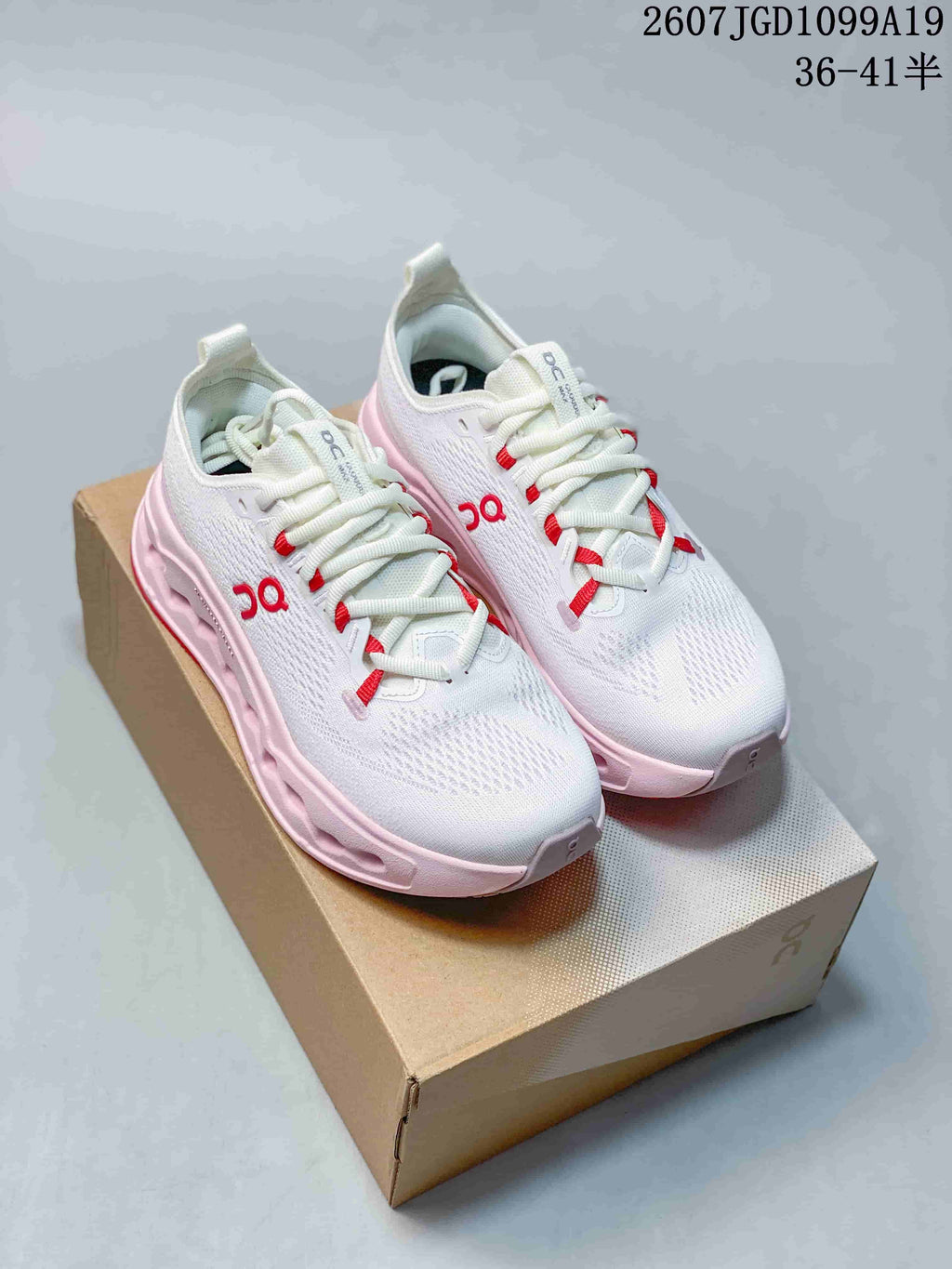 Pair of white On Cloudtilt sneakers with pink midsoles, red accents and a shoebox; overlay shows style code 2607JGD1099A19 and size range 36–41.5.