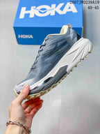 Side profile of the gray low-top running shoe showing the mesh-textured upper, white midsole, and cream outsole.