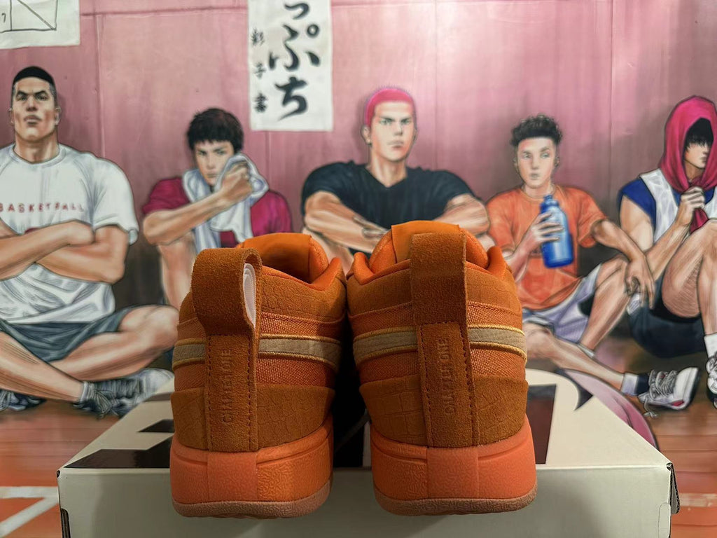 Rear view of orange Nike low-top sneakers showing heel tabs and textured panels