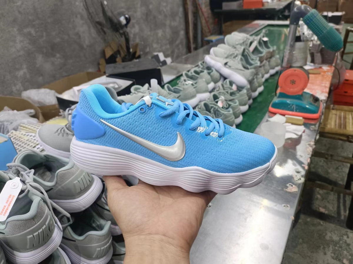 Blue Nike lace-up sneaker with a metallic silver Swoosh and white ridged sole
