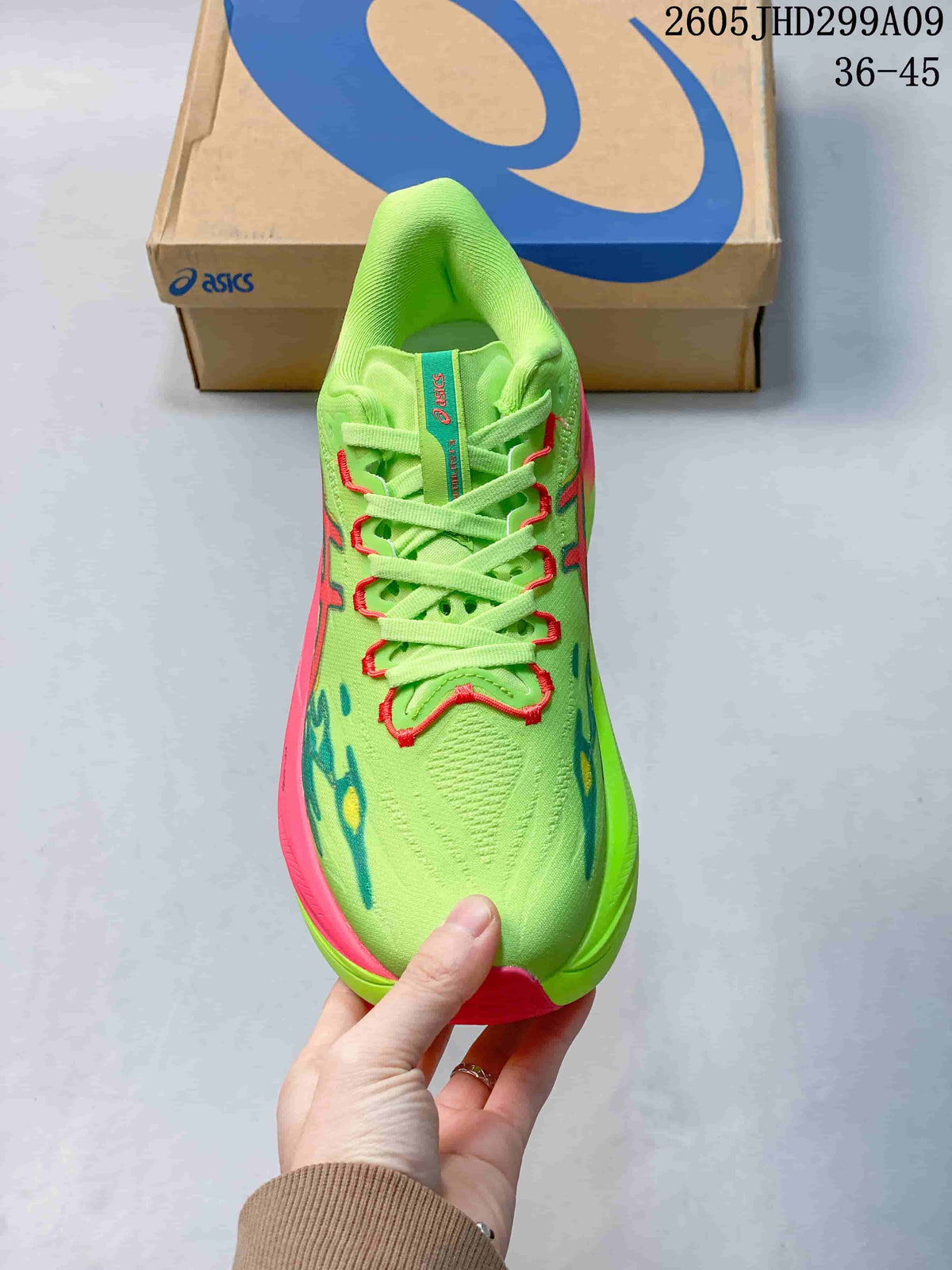 Top view of the lime green lace-up running shoe with pink and teal details