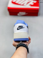 Rear view of the white Nike Full Force LO sneaker showing the black Nike logo, blue outsole edge and padded blue collar.
