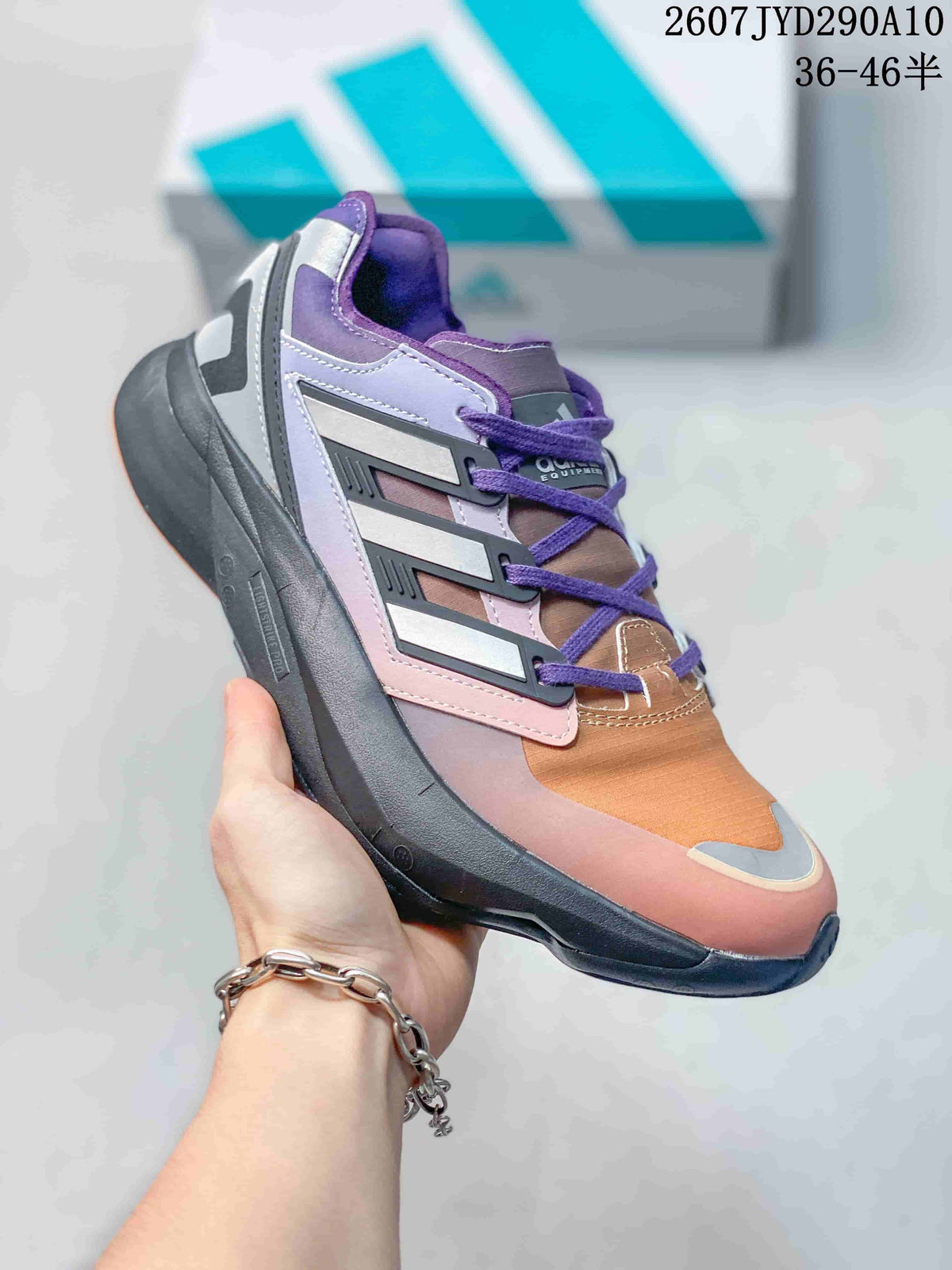 Side view of a purple, orange, and gray adidas Equipment Adios Pro sneaker with purple laces and a dark sole.