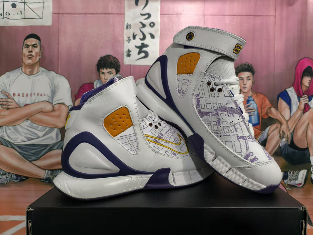 Pair of white, purple, and gold high-top basketball sneakers with forefoot straps and map-style graphics.