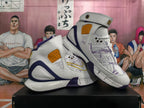 Pair of white, purple, and gold high-top basketball sneakers with forefoot straps and map-style graphics.