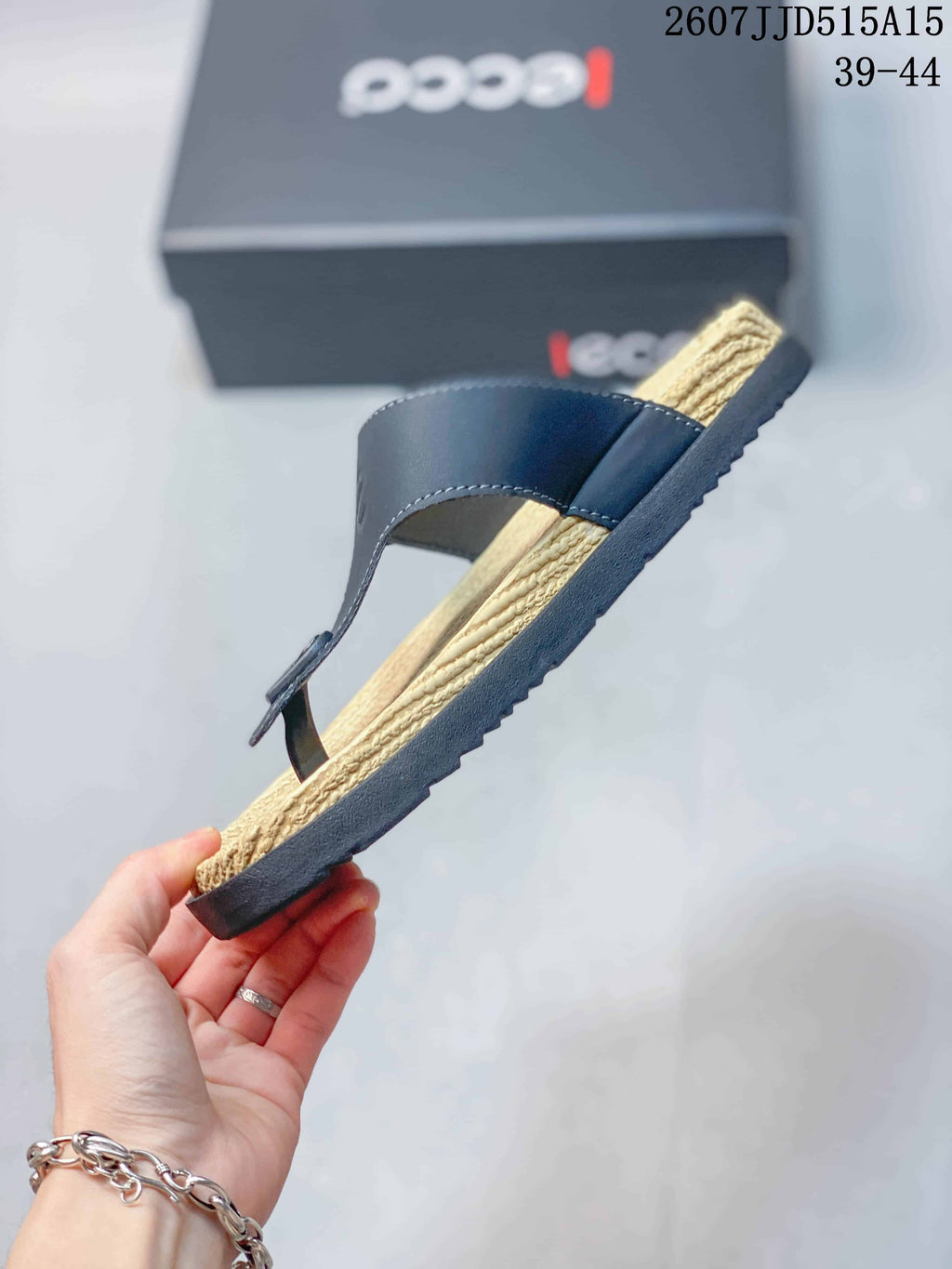 Side profile of the black sandal showing the layered footbed, textured outsole, and adjustable strap.