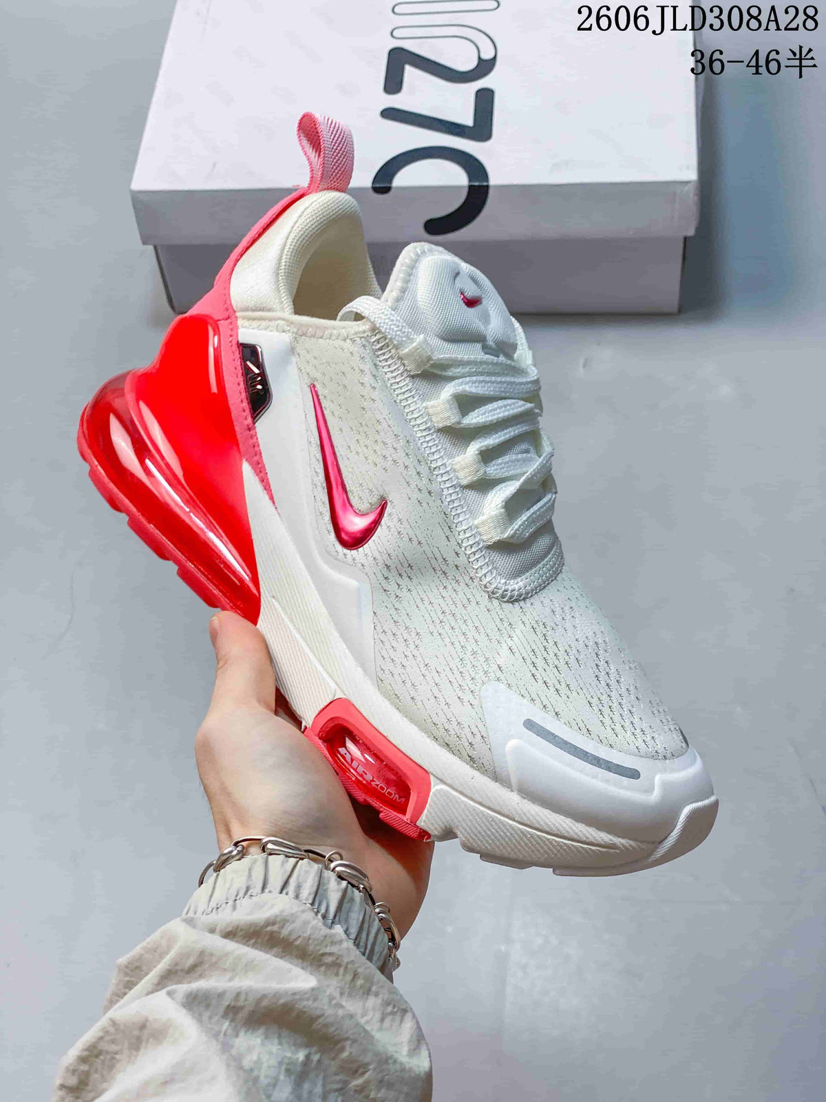 Angled side view of a white and red Nike Air Max 270 Premium sneaker