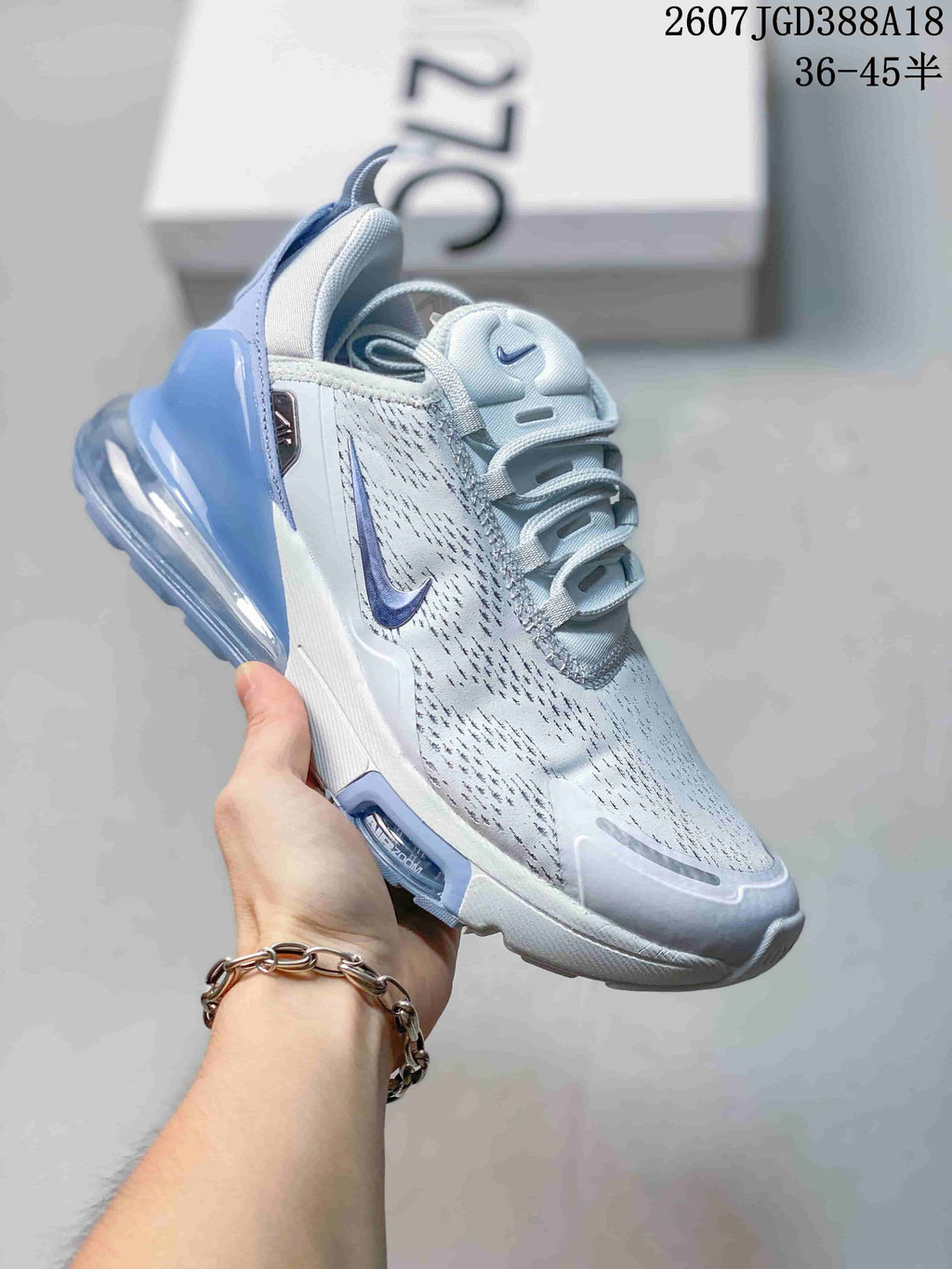 White Nike Air Max 270 Premium sneaker with blue accents and a translucent blue heel air unit.