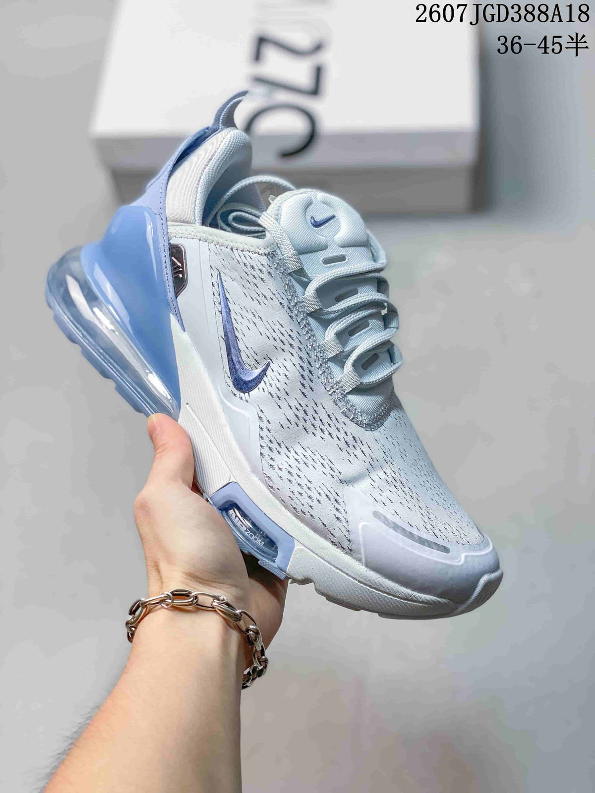 White Nike Air Max 270 Premium sneaker with blue accents and a translucent blue heel air unit.