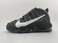 Side view of a black and dark gray Nike low-top sneaker with a large silver Swoosh and chunky segmented sole