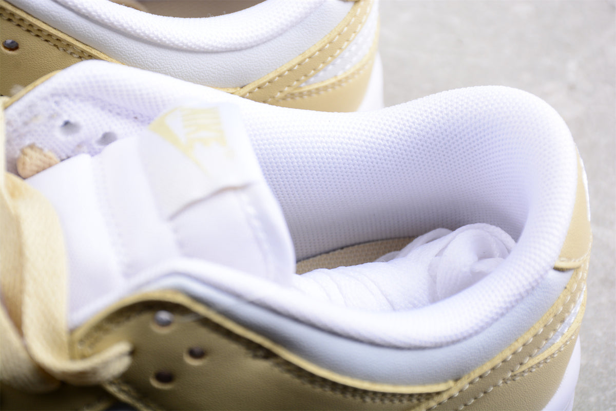 Close-up of the padded white collar, tongue, laces, and pale cream upper panels.
