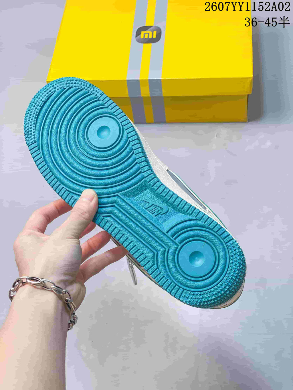 Close-up of the turquoise outsole with circular tread pattern