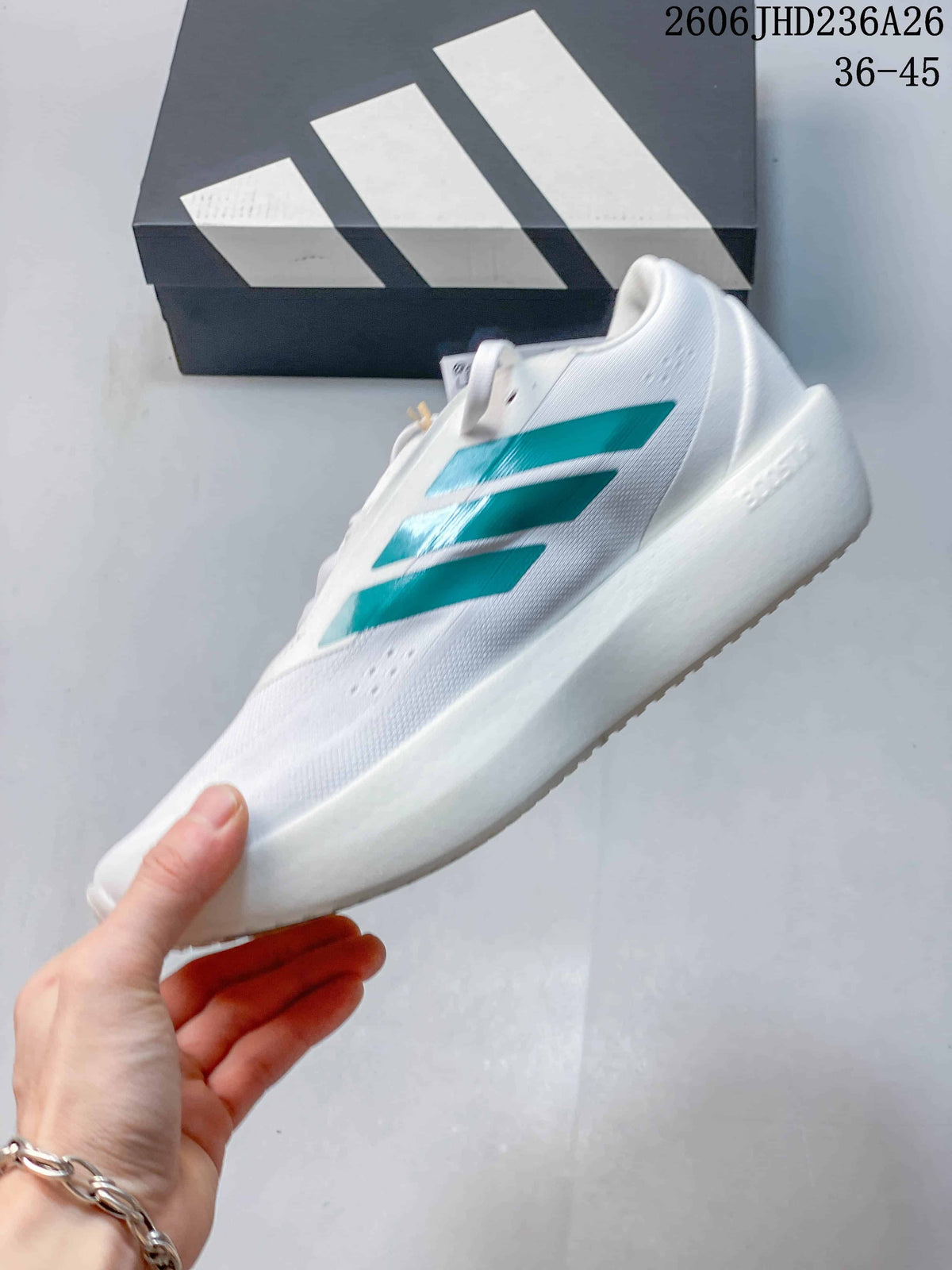 Side profile of a white ZenBoost shoe with green stripes and a sculpted sole.