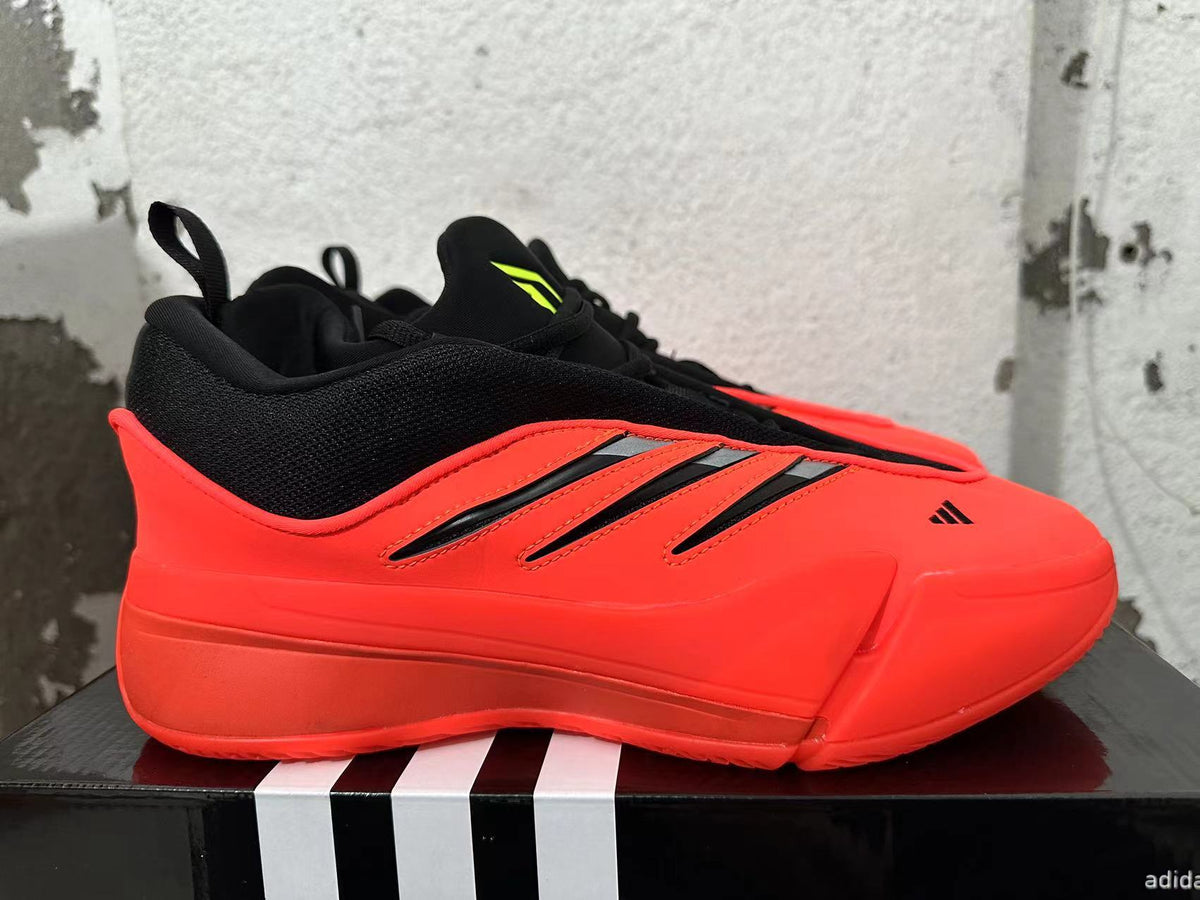 Side profile of a red Adidas Dame 9 shoe with black stripes