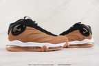 Side view of the brown and black sneakers showing the oval side logo and sculpted upper
