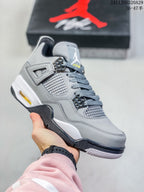 Close-up of a grey high-top sneaker with grey side mesh, dark eyelets, a white midsole section, and a black outsole.
