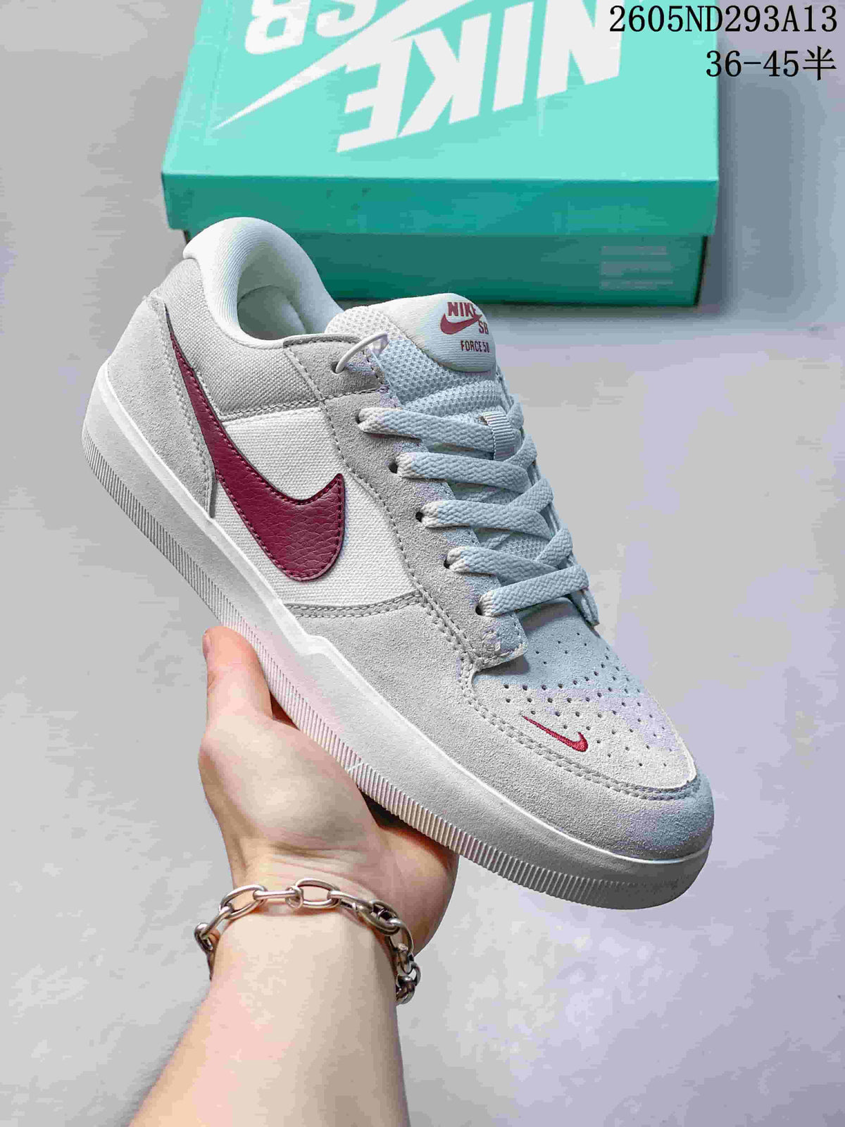 Light gray Nike SB Force 58 low-top shoe with burgundy Swoosh and perforated toe.