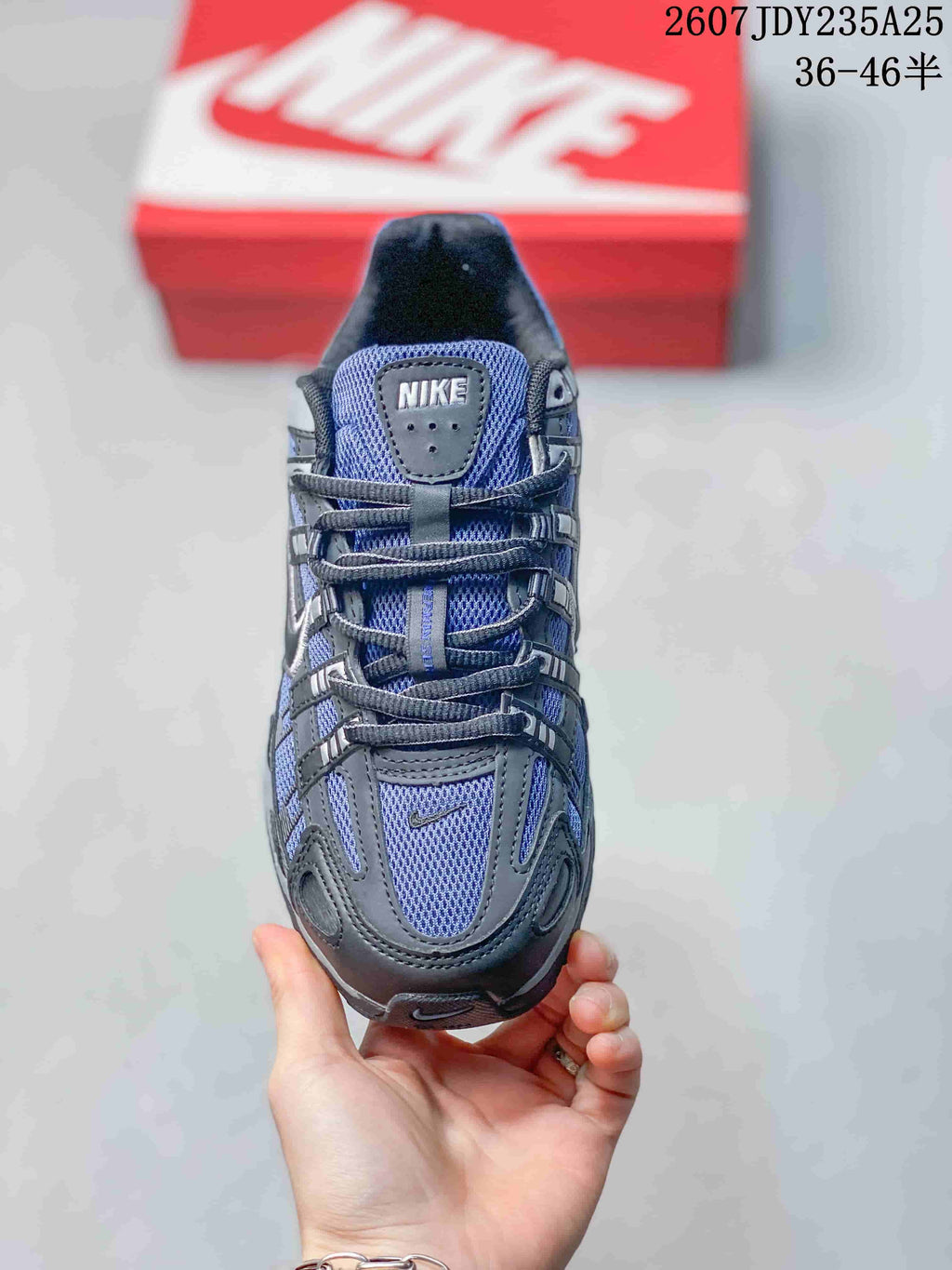 Top view of a blue and dark gray Nike P-6000 sneaker showing the mesh tongue, laces and layered toe design.
