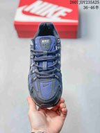 Top view of a blue and dark gray Nike P-6000 sneaker showing the mesh tongue, laces and layered toe design.