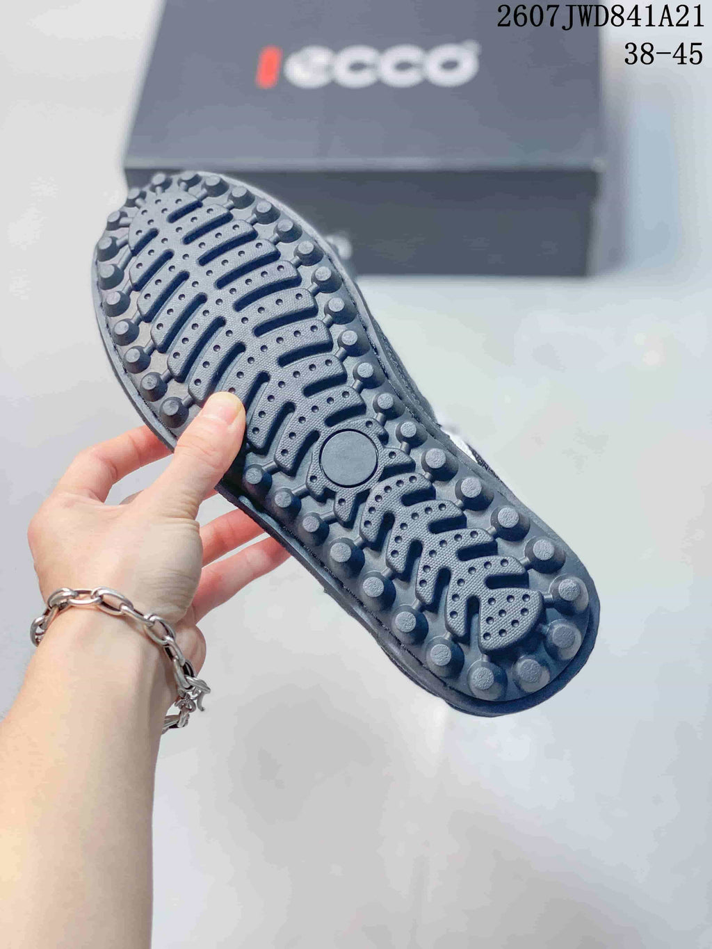 Close-up of the textured rubber outsole showing raised circular tread elements and grooves.