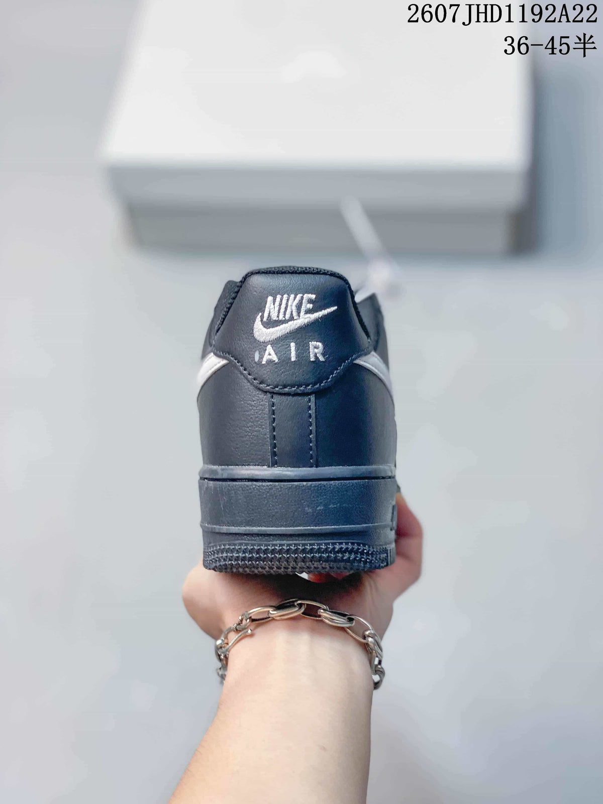 Rear view of the black sneaker showing the branded heel tab and rubber outsole.