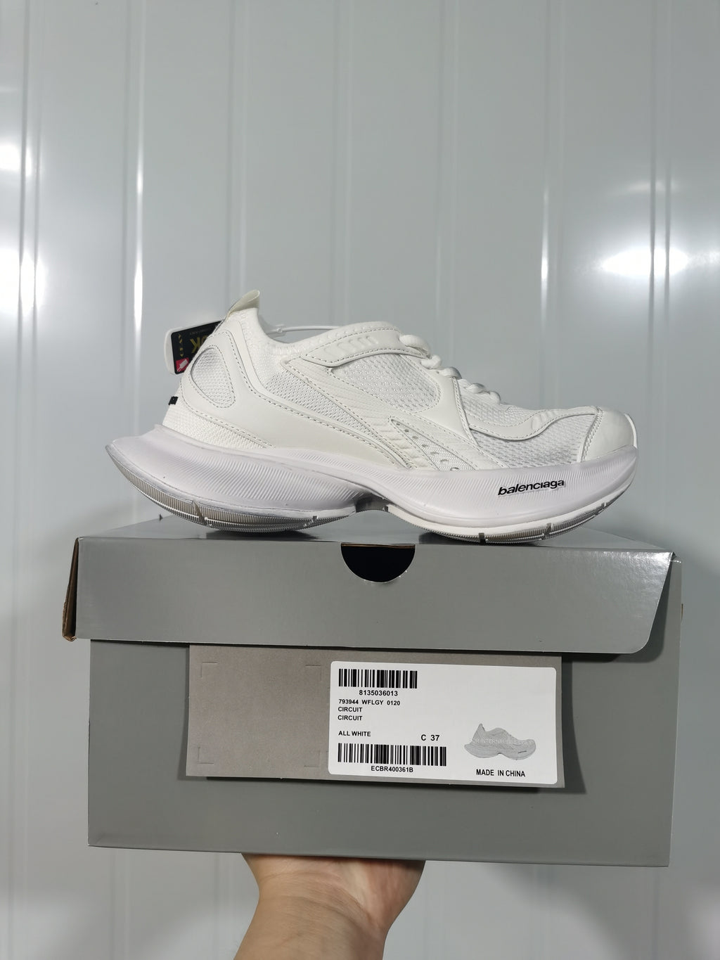 White Balenciaga Circuit sneaker displayed above its box, with the box label showing style 793944 WFLGY 0120, color ALL WHITE, and size C 37.