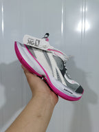 Angled view of the grey, white and pink Balenciaga Circuit sneaker with visible side branding and pink outsole.
