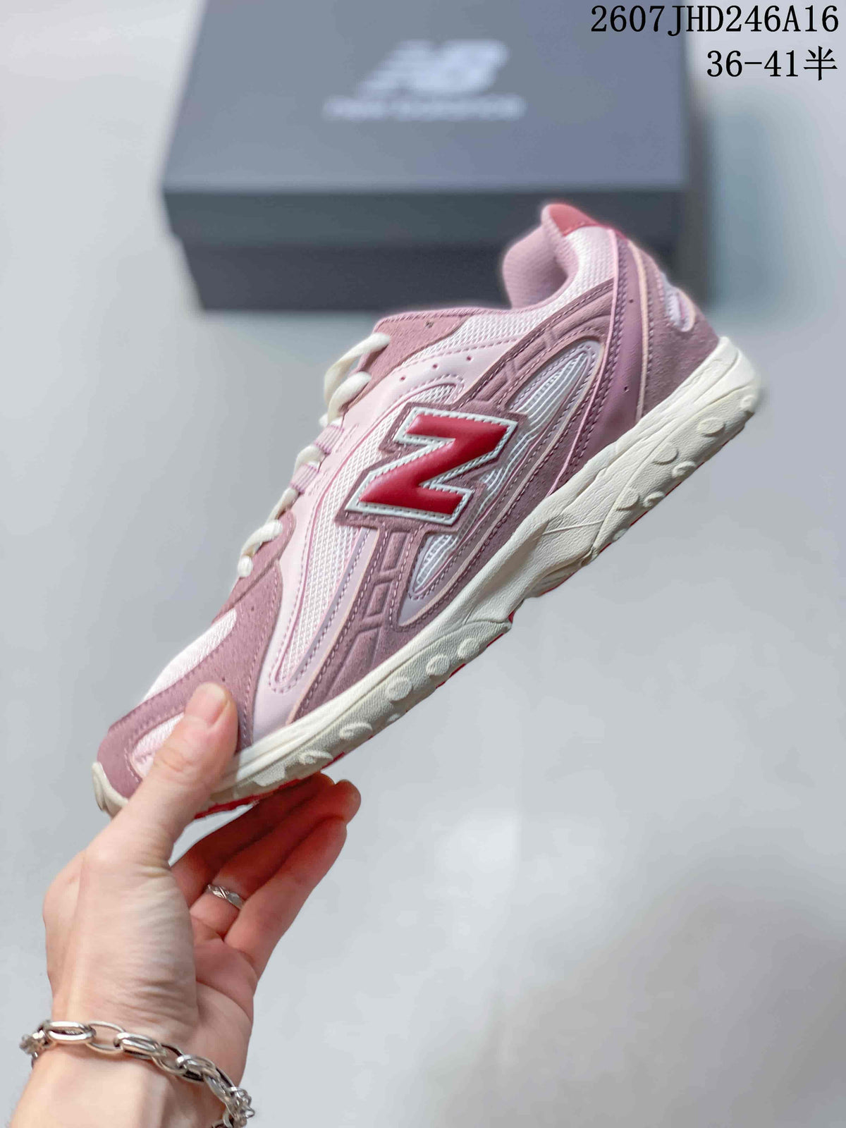 Side view of a pink low-top sneaker showing the large New Balance logo, layered panels, and textured outsole.